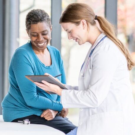 Healthcare Practice owner meeting with patient - simply bookkeeping services practices like this